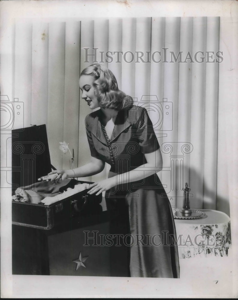 1950 Model demonstrating how to pack a suitcase-Historic Images