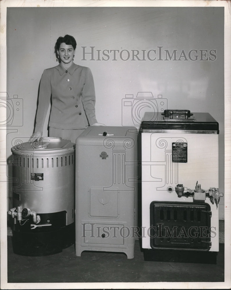 1952 Press Photo A woman with a display of furnace units for homes,-Historic Images