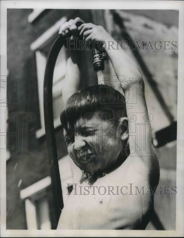 1948 11 year old Jimmy Stiney Keeps Cool with hose on hottest day - Historic Images