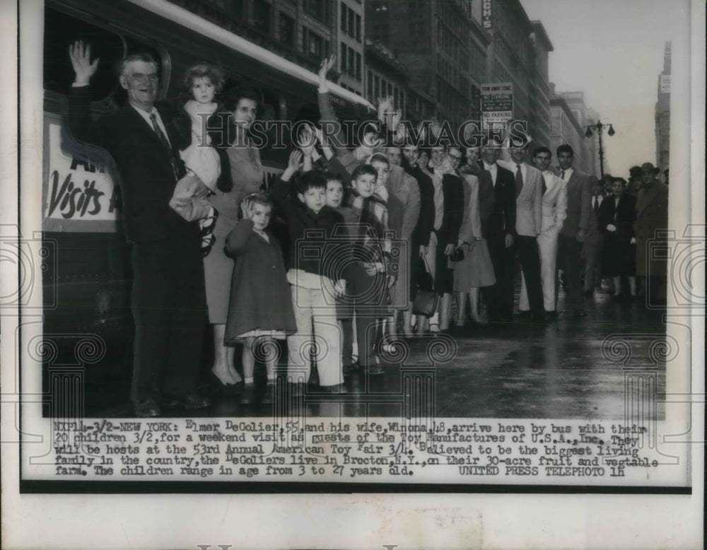 1956 Press Photo Family posing in front of toy manufacturer in New York - Historic Images