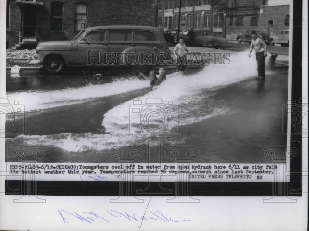 1951 Chicago, Ill.youngsters cool off at fire hydrant in heat wave - Historic Images