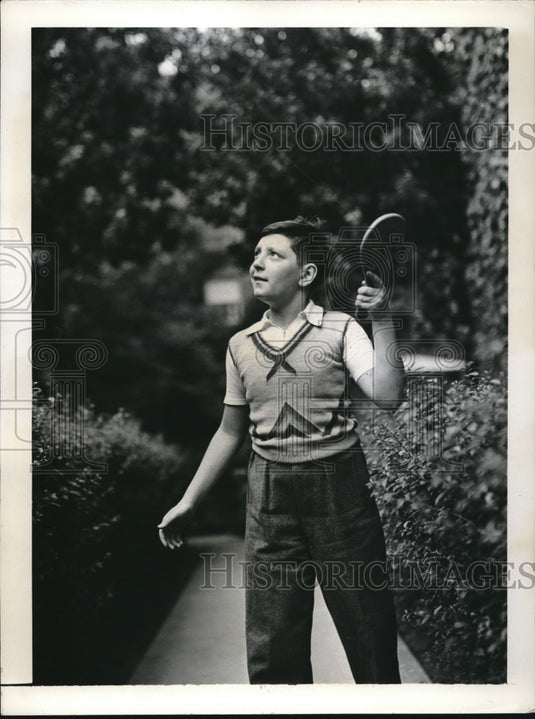 1937 Press Photo Young Boy Bats Hi Li Ball With Paddle In Park Next to Shrubs - Historic Images
