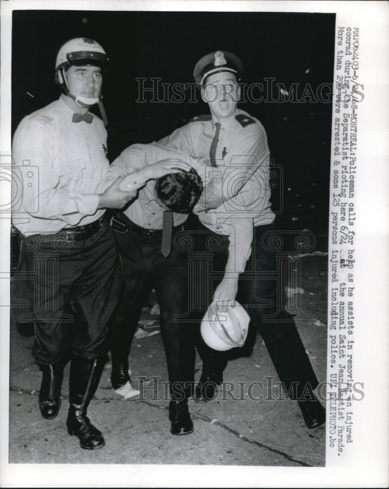 1968 Press Photo Police Escort Injured Comrade at St. Jean Baptiste Parade Riots - Historic Images