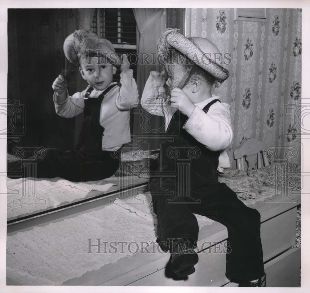 1952 Bobby Edge, Boy in Millinery Shop Tries Hats - Historic Images