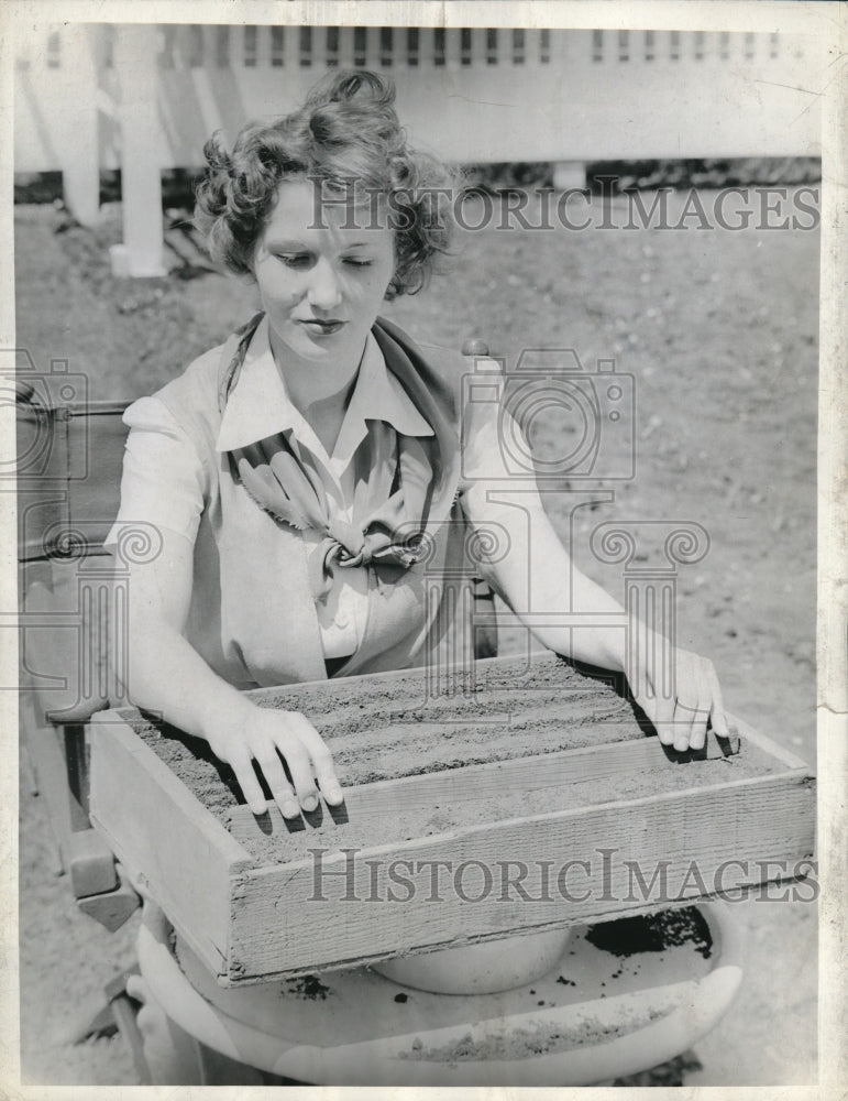 1954 Pretty lady helping with gardening - Historic Images