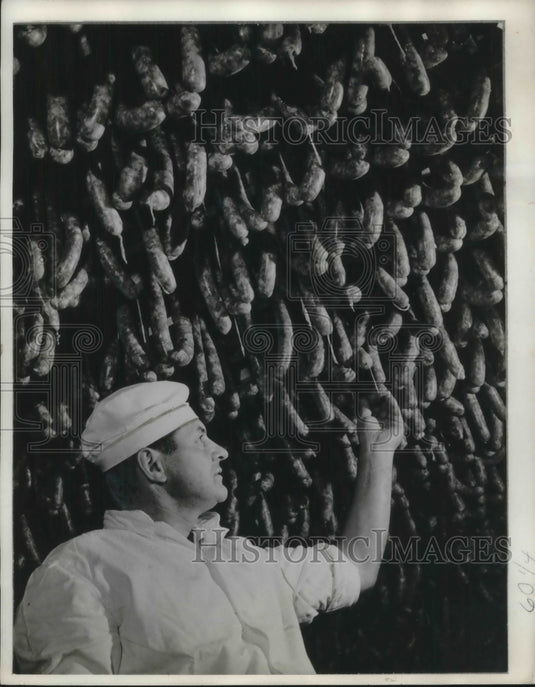 1968 Manager of Meat dressing plants Tamas Loga under sausages - Historic Images