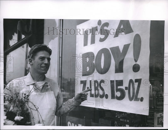 1958 Grocer Harry Suttmiller & sign for baby son's birth - Historic Images