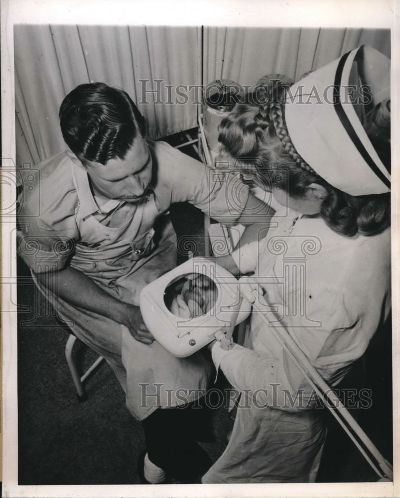 1944 Matthew Smith injured with splinter, with nurse Vivianne Beegle - Historic Images