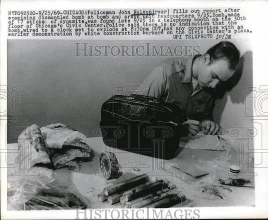1969 Press Photo Chicago Policeman John Nelson Examining Dismantled Bomb - Historic Images