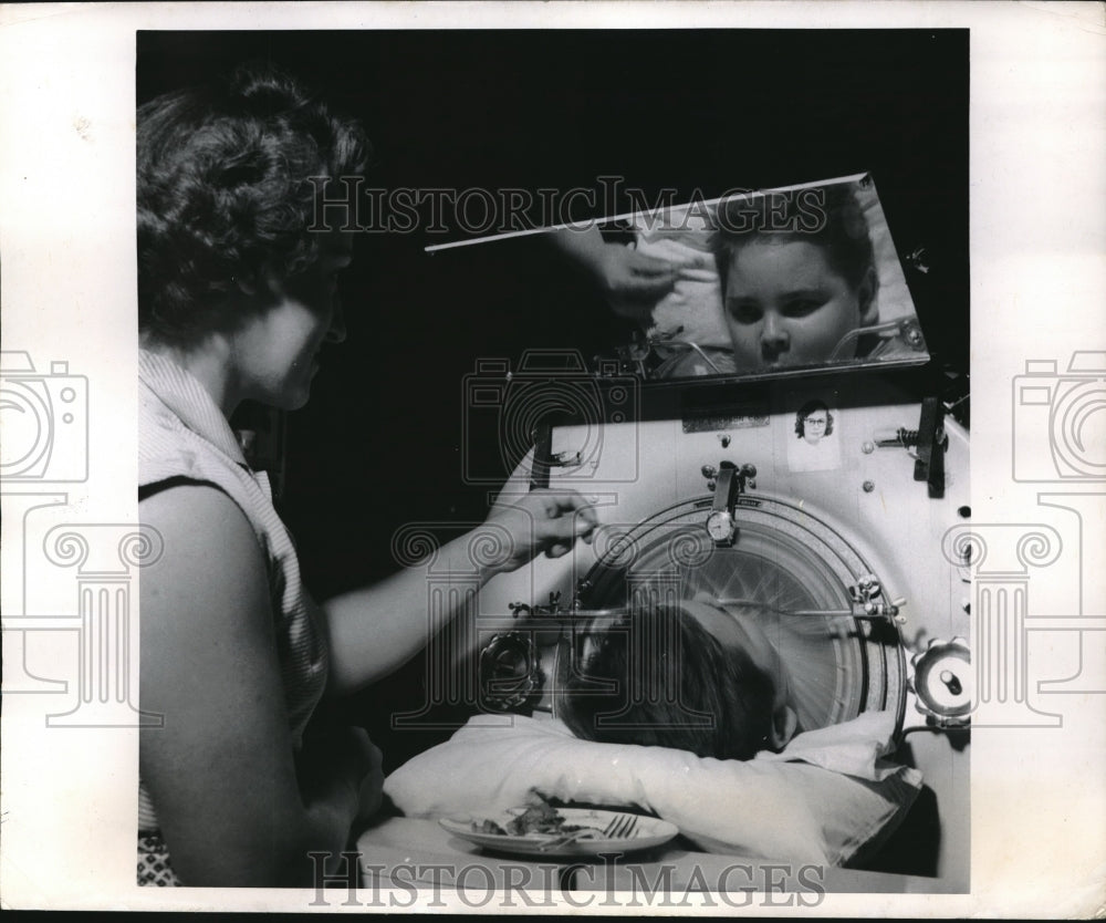 1954 Press Photo Mrs Erle Garnett helps son Clyde eat in their home NYC - Historic Images