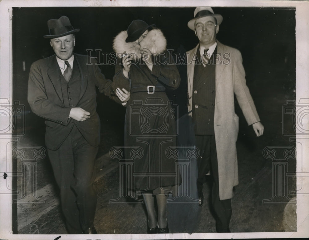 1935 Woman with two police officers leaving DA office in New York - Historic Images