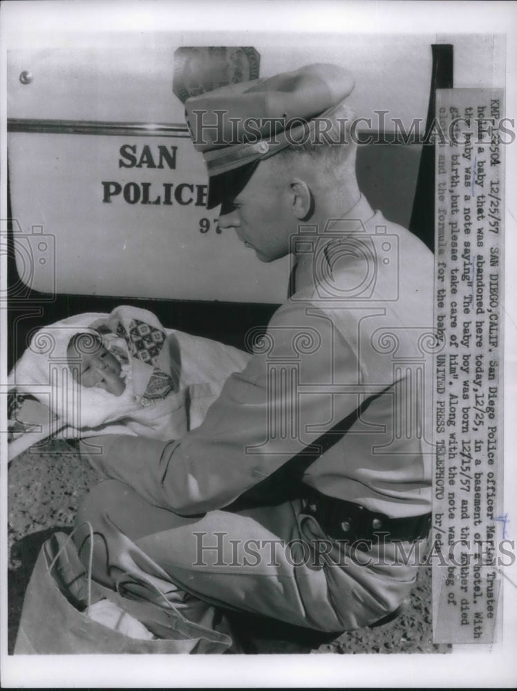 1957 Press Photo Policeman Marion Trustee Holds Baby Abandoned In Hotel Basement - Historic Images