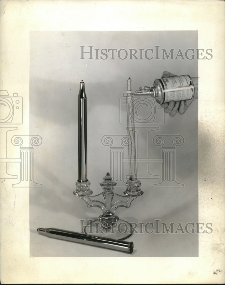 1937 Press Photo Hand Lights Tapered Candle on Candelabra With Some Weird Torch - Historic Images