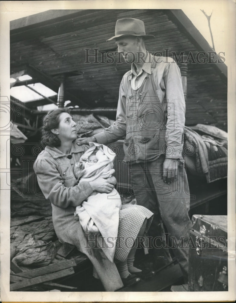 1945 Charlie McLevins comforts his wife after tornado destroyed home - Historic Images