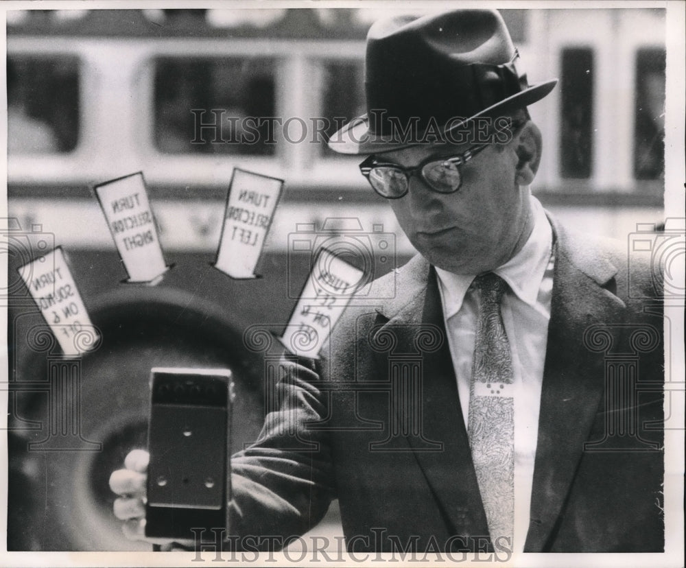 1958 The thing, examined by a man on the street - Historic Images