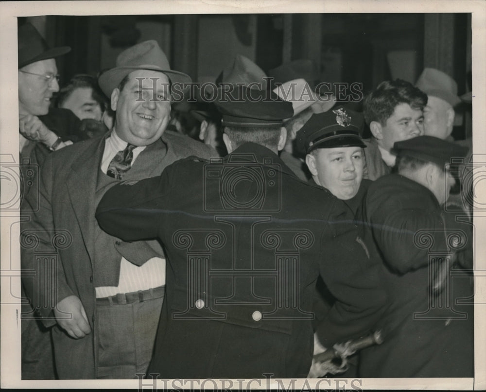 1946 &quot;Tiny&quot; Smiles As Cleveland Police Try to Push Him Back During - Historic Images