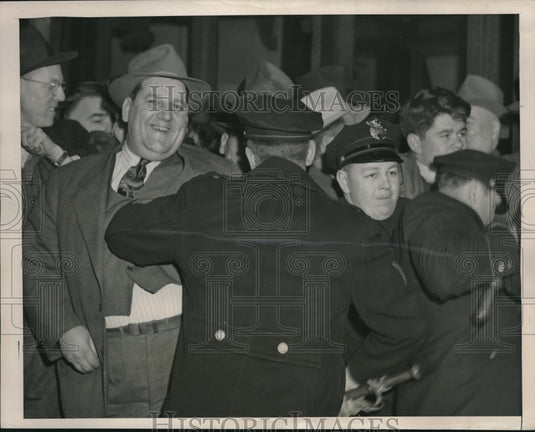 1946 "Tiny" Smiles As Cleveland Police Try to Push Him Back During - Historic Images