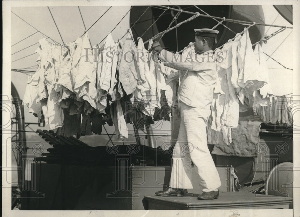 1929 Press Photo Japanese Sailor Hanging Wash on Cruiser Asama - Historic Images