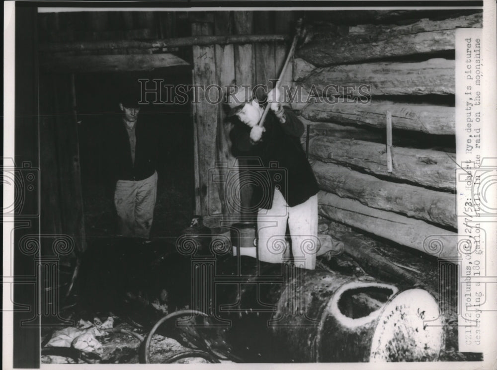 1953 Press Photo Deputy Hobert Dye destroys a still. - Historic Images