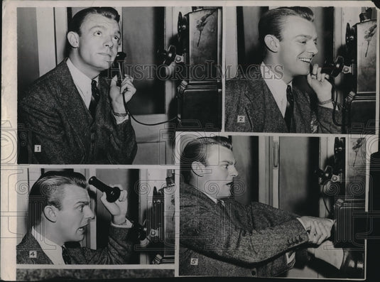 1962 man humorously demonstrating use of old fashioned telephone - Historic Images