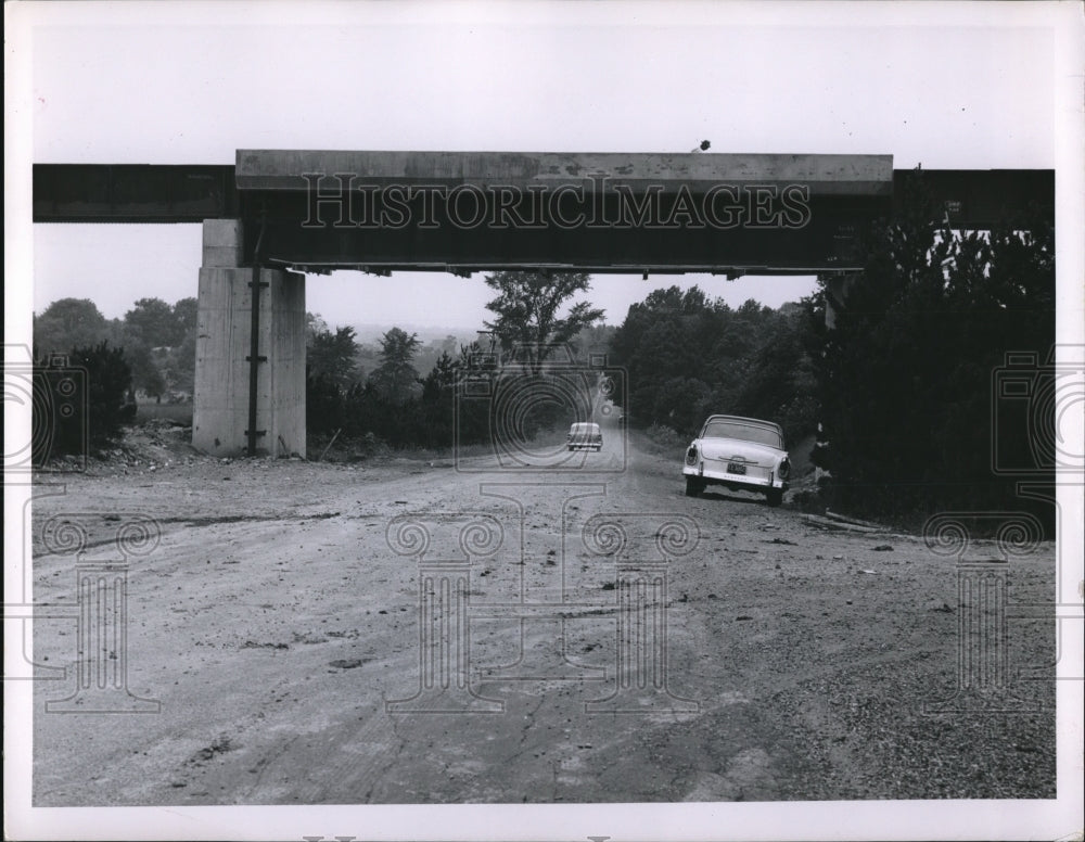 1956 Press Photo Car Sits On Road Under Pennsylvania Railroad Bridge - Historic Images