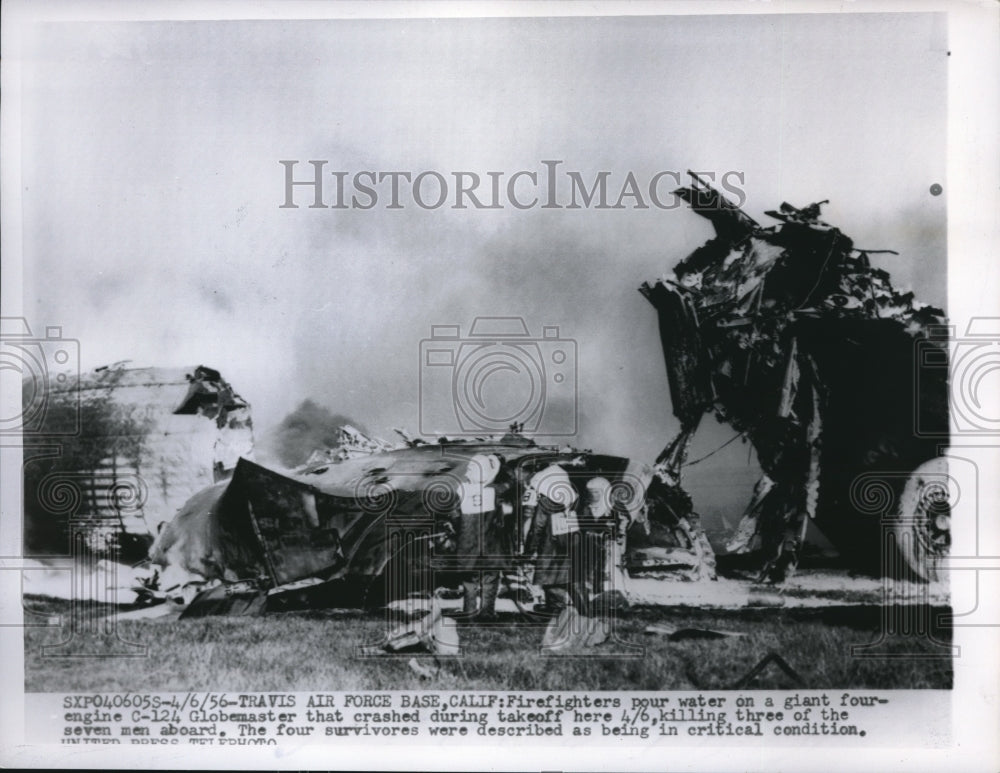 1956 Press Photo Firefighters pour water on a 4 engine C-124 at Travis Airbase - Historic Images