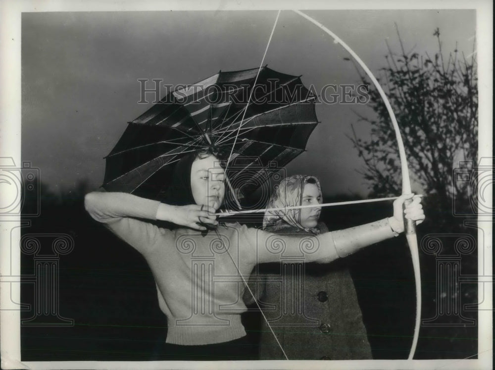 1937 Ruth Feely as Olive Price both of New York City holds umbrella - Historic Images