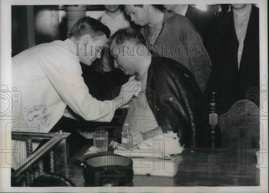 1938 Lieut Gallagher being treated for burns. - Historic Images