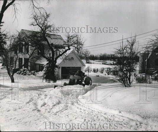 1953 Farmer Plowing his own road after storm in Michigan - Historic Images