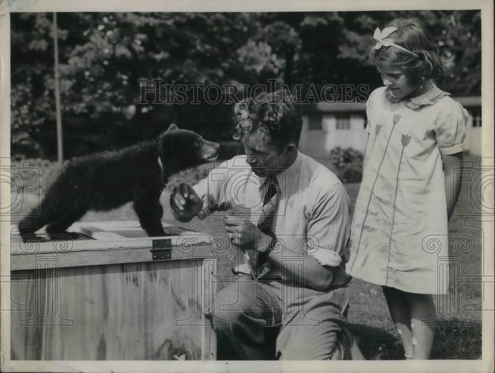 Press Photo of Eva the black bear being attended to by Harold Patch and a orphan - Historic Images