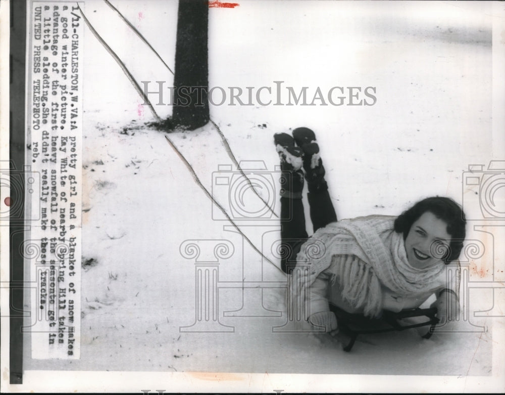 1956 Press Photo Pretty Girl Kay White Slides Down Snowy Hill On Sled - Historic Images