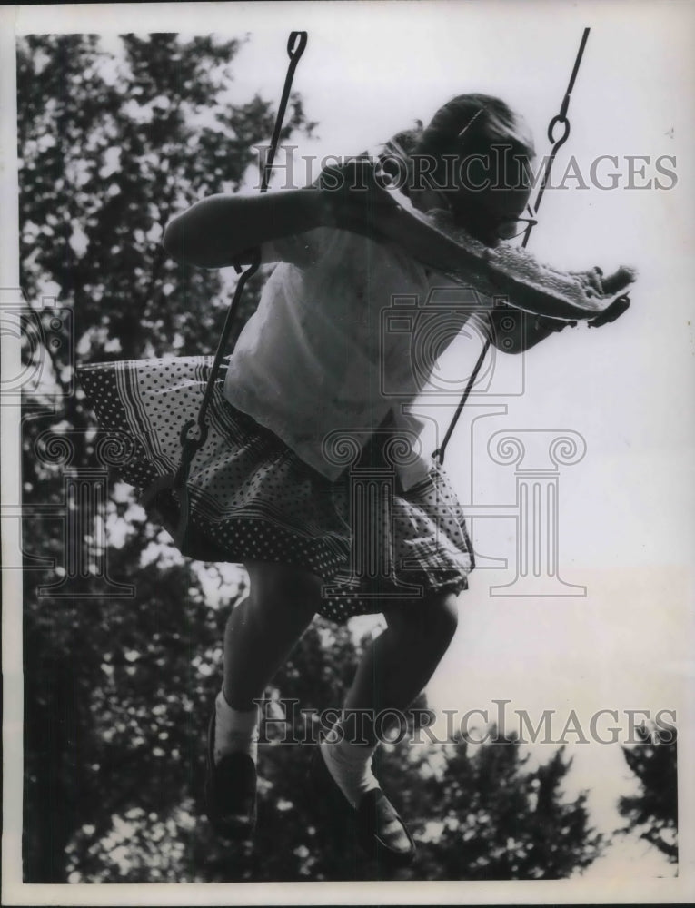 1958 Press Photo Susan Gibbs Swinging as She Eats Watermelon - Historic Images