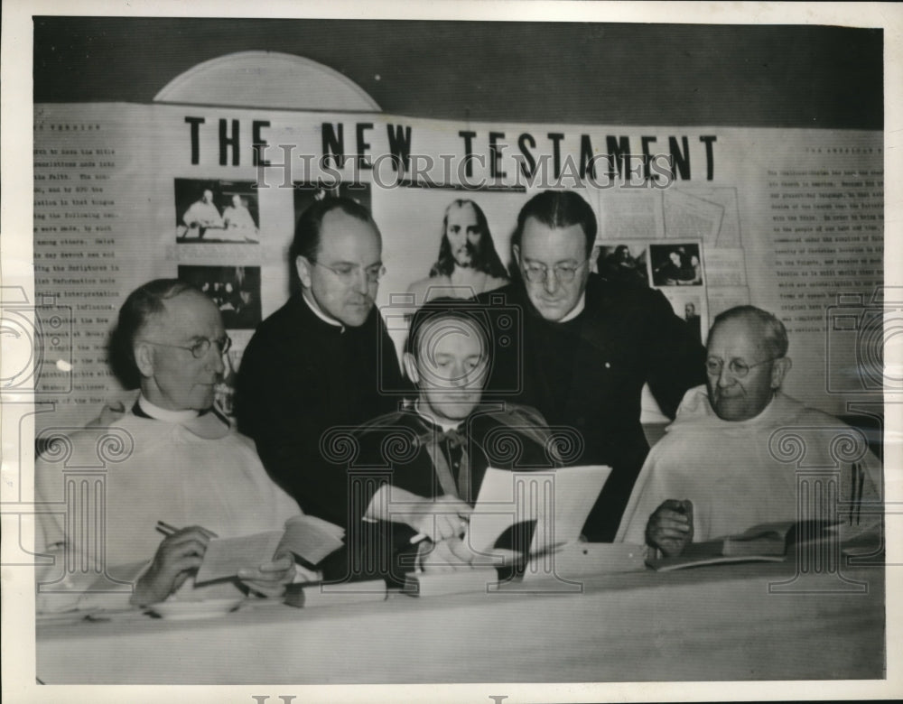 1941 Press Photo Rev. Ed Donze shows new bible at Catholic U in DC - nec30717 - Historic Images