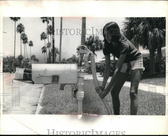 1973 Kim Whyte of St.Peterburg Fla. shows how her mailbox works. - Historic Images