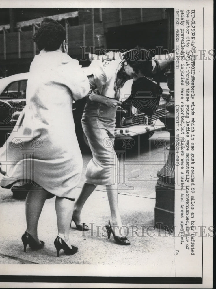 1958 Ladies momentarily inconvenienced by Westerly winds in Detroit - Historic Images