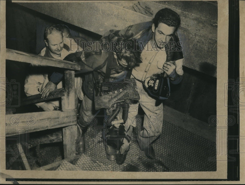 1957 Press Photo Fireman drags buddy out of collapsed sewer - nec34346 - Historic Images