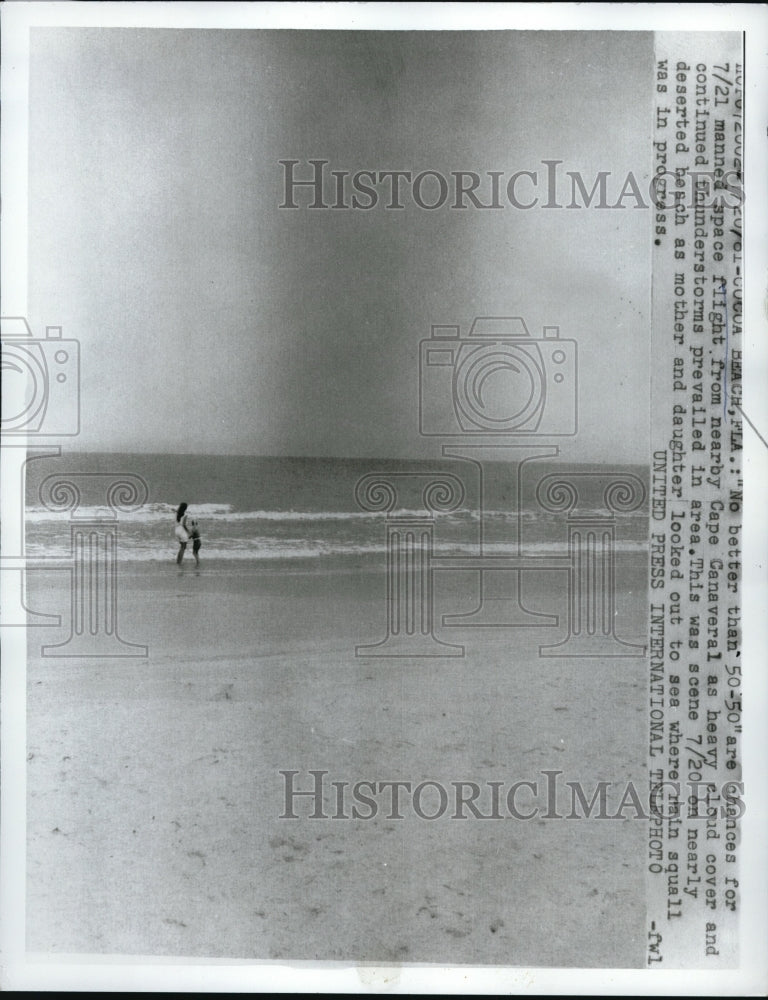 1961 Press Photo Cocoa Beach, Fla woman on beach as thunderstorm rolls in - Historic Images