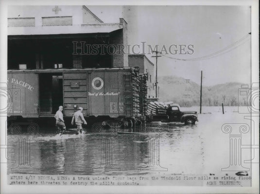 1951 truck unload flour bags from the windgold flour mills. - Historic Images