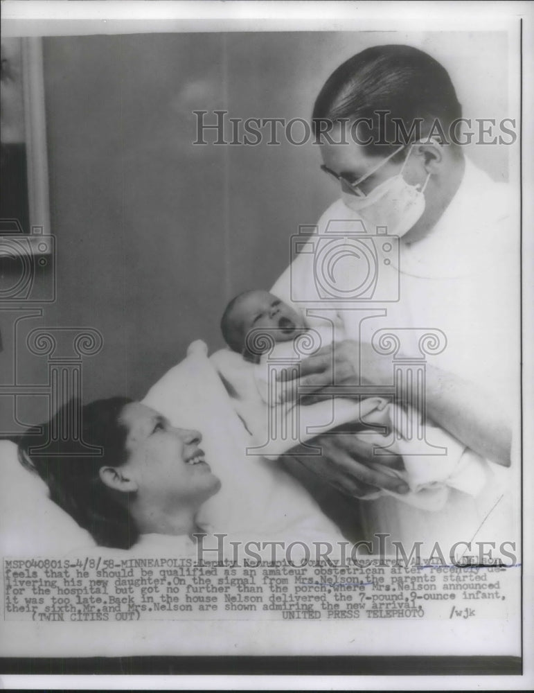 1958 Press Photo Minneapolis, Minn MAn hold baby daughter he delivered-Historic Images