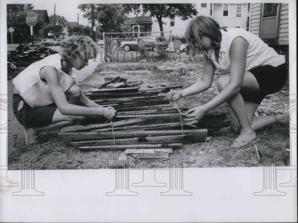 1966 Darlene Twomely and Delores Haws bundling kindling - Historic Images