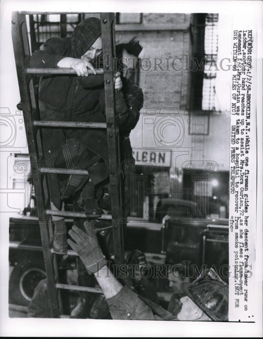 1958 Press Photo Mrs. Dora gets help form a fireman. Brooklyn NY - nec39439 - Historic Images