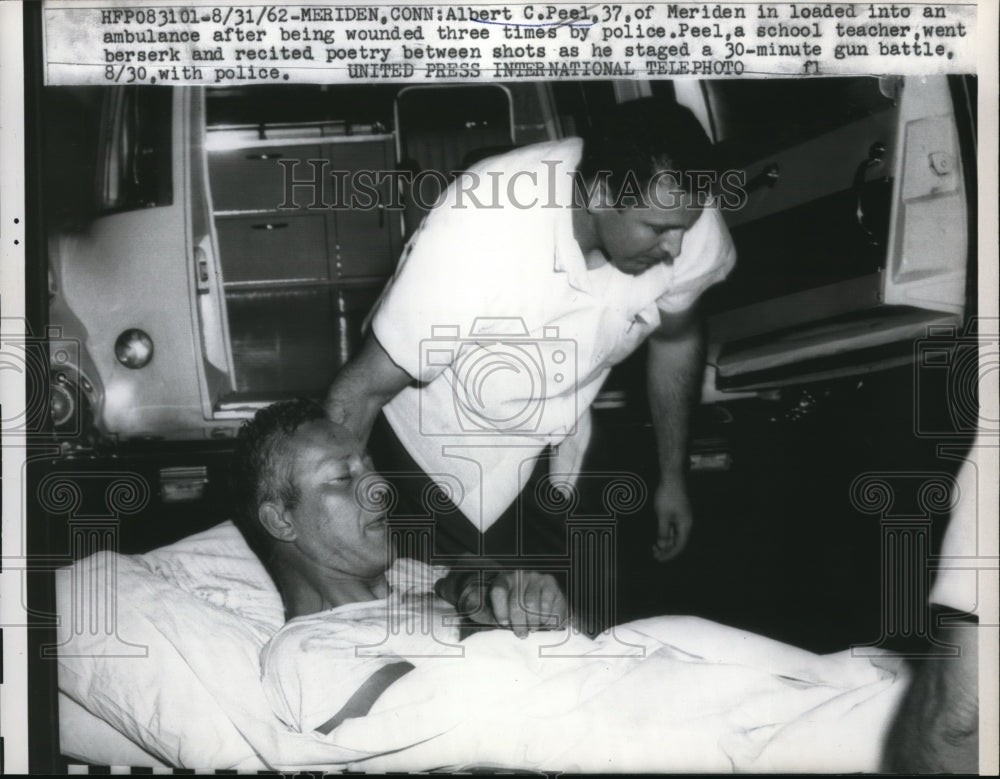 1962 Press Photo Albert C. Peel loading into a ambulance after being wounded. - Historic Images