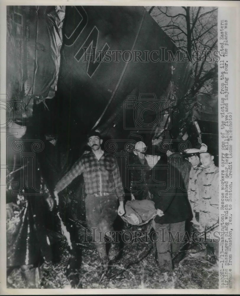 1948 Press Photo Rescue workers carry one of the victims a plane crash. - Historic Images