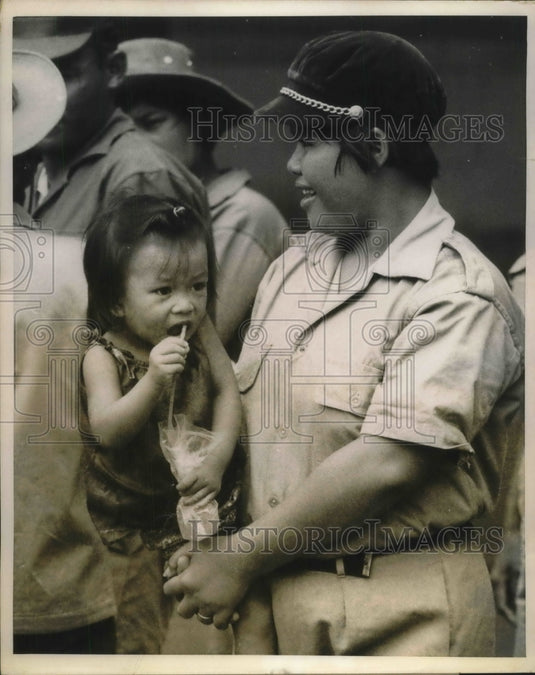 1970 Press Photo A female volunteer helping out a little kid. - Historic Images