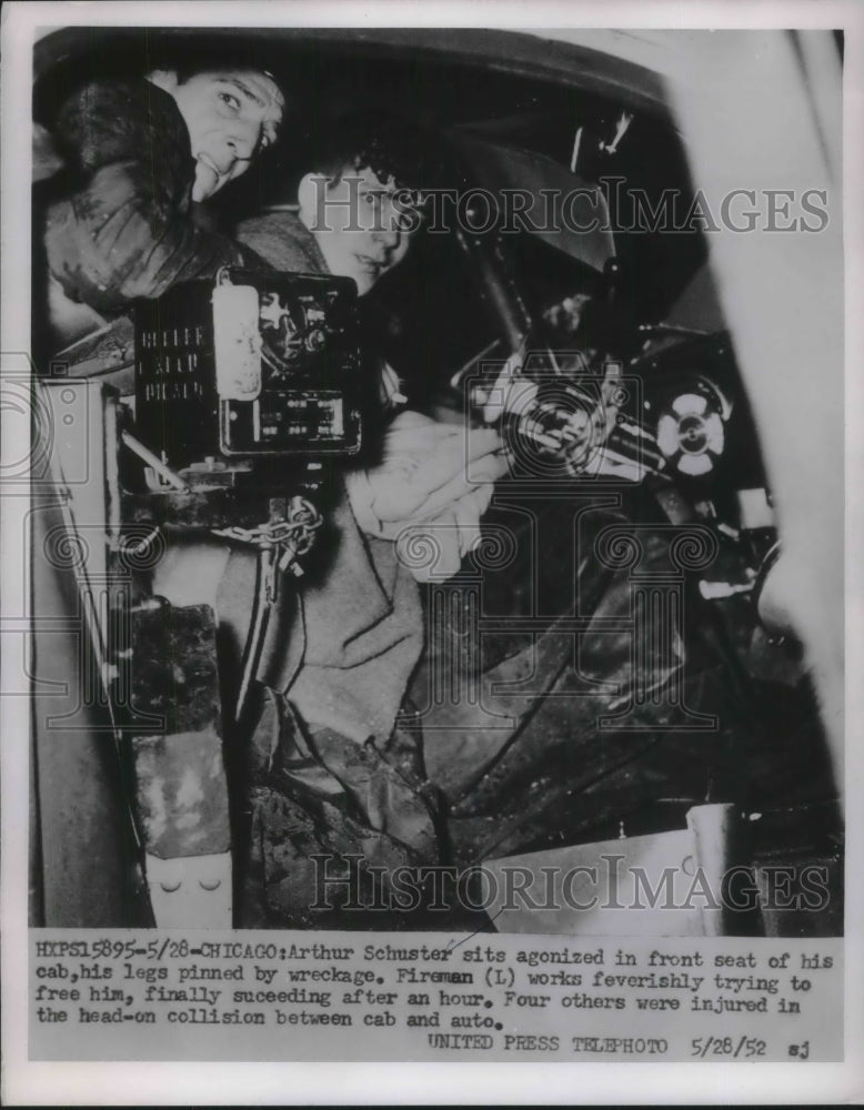 1952 Press Photo Arthur Schuster legs pinned by wreckage as firemen assist. - Historic Images