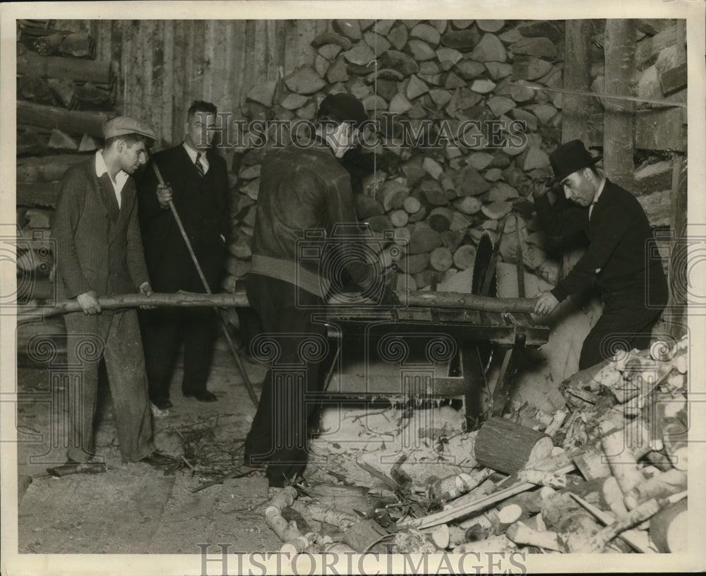1930 Press Photo Workers JM Daly And William Rogers Saw Wood Next To Pile - Historic Images