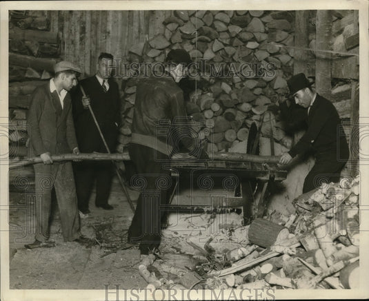 1930 Press Photo Workers JM Daly And William Rogers Saw Wood Next To Pile - Historic Images