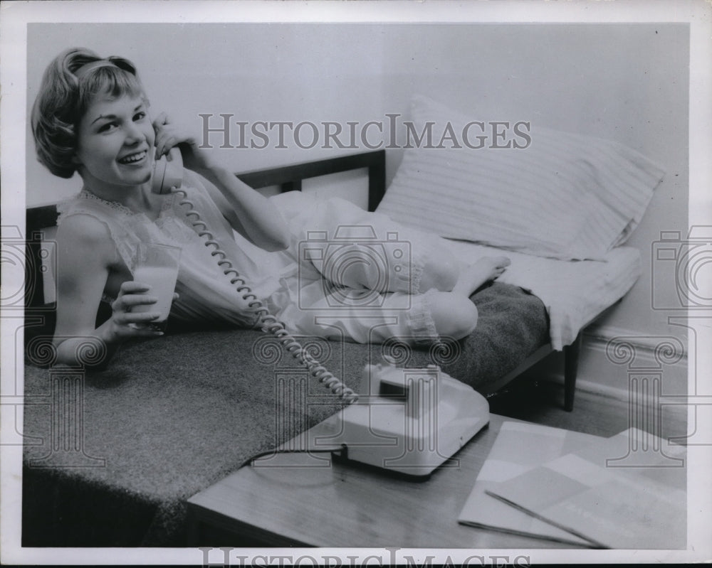 1958 Press Photo Blonde Teenager Relaxes On Cot Bed While Talking On Phone - Historic Images