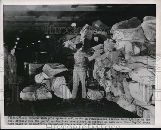 1951 Press Photo NYC, workmen pile mail sacks at Penn Stattion during RR strike - Historic Images