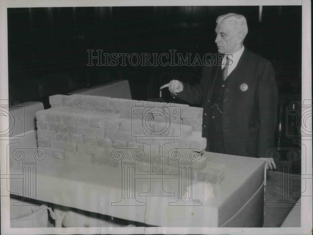 1937 Press Photo Gus Hueher pointing to the bricks that collapsed. - Historic Images